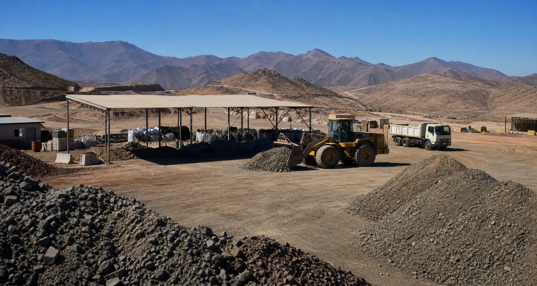 Small and medium Chilean mining producer yard with loader and ore stockpiles